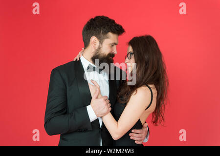 Lets dance tonight. Elegant couple in love tender hug dancing red background. Happy together. Man in tuxedo and woman black dress dancing at party. Passionate couple dancing. Feel rhythm of heart. Stock Photo