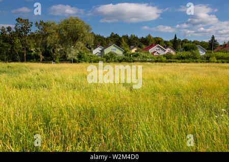 Colorful wooden homes nestled among lots of greenery in a suburb of Turku, Finland. Stock Photo