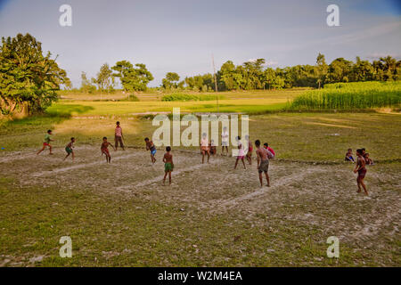 Children playing ‘Daricha’ a traditional game especially played in the rural areas, in Bangladesh. Traditional sports like Daricha and Kabadi, are rapidly disappearing in the face of western sports like cricket which attract sponsorship. Typically such games require only land and people and can be played without any gear or equipment. Kurigram, Bangladesh. July 22, 2009. Stock Photo