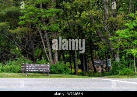 Road with signs in Shenandoah Blue Ridge appalachian mountains on skyline drive for lodge, picnic campground amphitheater visitor center and trails Stock Photo