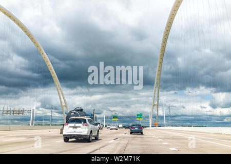 Dallas, USA - June 7, 2019: Downtown highway in city in summer with Tom Landry Freeway and traffic with Margaret McDermott Bridge on cloudy day Stock Photo