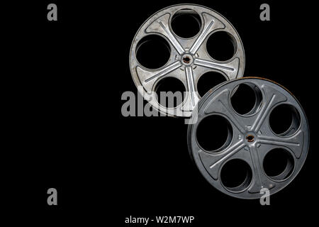 Two vintage film reels on a black background with copy space Stock