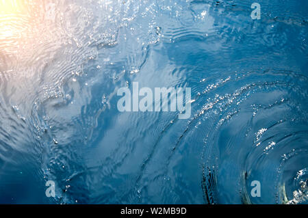 reflection of sunlight in the blue waves of the sea Stock Photo