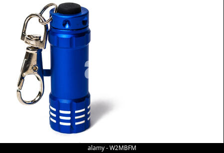 Standing Small blue flashlight key chain on white paper background Stock Photo