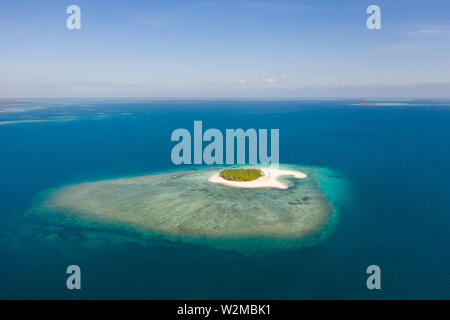 Patawan island. Small tropical island with white sandy beach. Beautiful island on the atoll, view from above. Nature of the Philippine Islands. Stock Photo