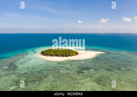 Patawan island. Small tropical island with white sandy beach. Beautiful island on the atoll, view from above. Nature of the Philippine Islands. Stock Photo