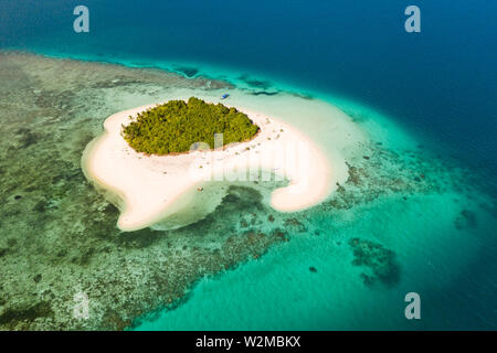 Patawan island. Small tropical island with white sandy beach. Beautiful island on the atoll, view from above. Nature of the Philippine Islands. Stock Photo