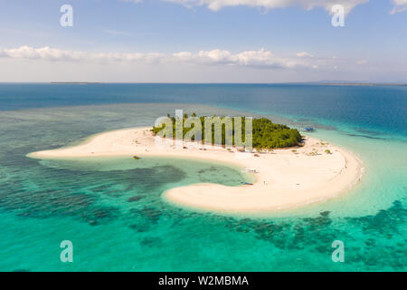 Patawan island. Small tropical island with white sandy beach. Beautiful island on the atoll, view from above. Nature of the Philippine Islands. Stock Photo