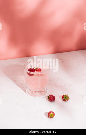 Summer juice with fresh raspberries in a glass on a light background Stock Photo