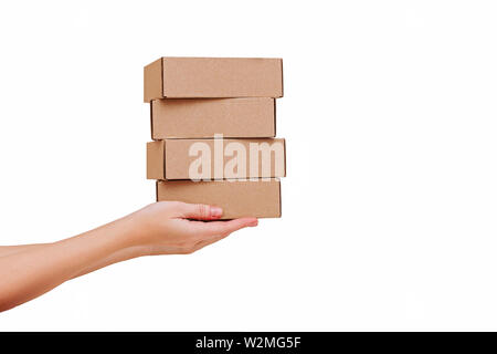 Woman's hands holding boxes stacked on white isolated background. Mock up. Stock Photo
