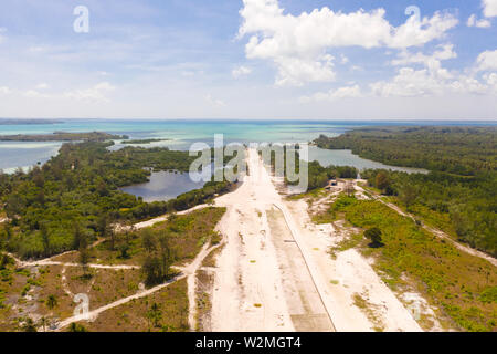 Runway on a tropical island, view from above. Balabac, Palawan, Philippines. Construction of the runway of the local airport on a tropical island. Stock Photo