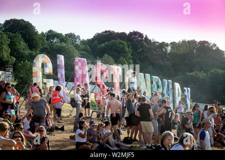 Crowd at the iconic ‘Glastonbury Letters’ above the Park area Glastonbury Festival 2019 in Pilton, Somerset Stock Photo
