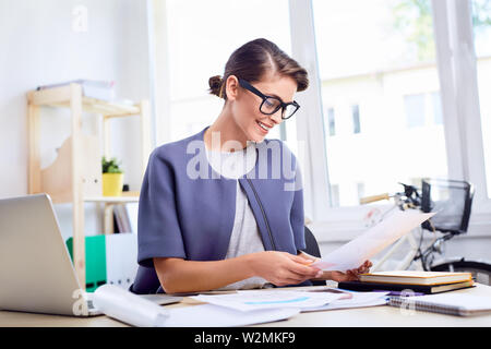 Businesswoman doing paperwork at office Stock Photo