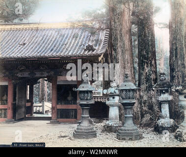 [ 1890s Japan - Lanterns at Niomon Gate, Nikko ] —   A rare view of Niomon in Nikko, as seen from the back. The gate was also known as Omotemon or Front Gate. The pots visible in the gate were displayed there between 1871 (Meiji 4) and 1897 (Meiji 30).  19th century vintage albumen photograph. Stock Photo