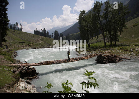 Srinagar, Indian-controlled Kashmir. 8th July, 2019. A man takes selfies on a wooden bridge over a river at Lidder Wath in Pahalgam, south of Srinagar city, the summer capital of Indian-controlled Kashmir, July 8, 2019. Credit: Javed Dar/Xinhua/Alamy Live News Stock Photo