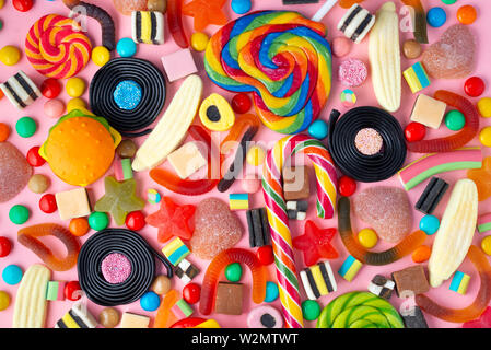 background of lollipops and candies on pink Stock Photo