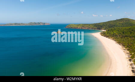 aerial view island with tropical sandy beach and palm trees. Malajon Island, Philippines, Palawan. tourist boats on coast tropical island. Summer and travel vacation concept. beach and blue clear sea water Stock Photo