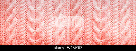 Knitted texture. Pattern fabric made of wool in trendy coral color. Background, copy space. Stock Photo