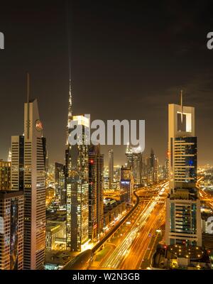 A view of the city skyline at dusk from the financial district of downtown Dubai, UAE, Middle East.