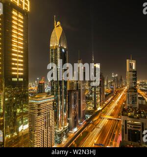 A view of the city skyline at dusk from the financial district of downtown Dubai, UAE, Middle East.