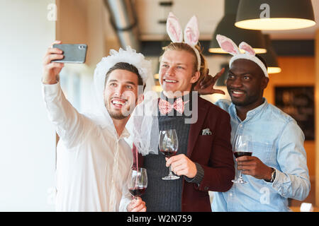 Friends make selfie at bachelor party in a bar as a reminder Stock Photo