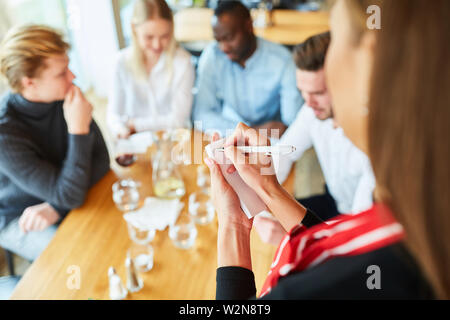 Waitress or waitress makes an order in the bistro or restaurant Stock Photo