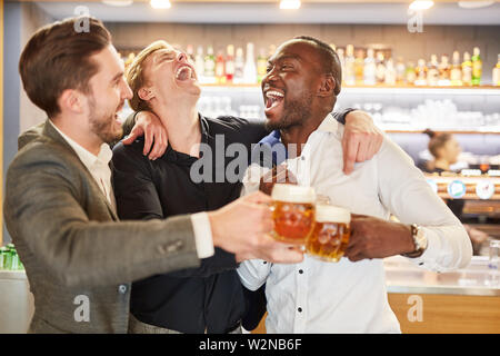 Friends on a men's evening having a beer in a pub or bar Stock Photo