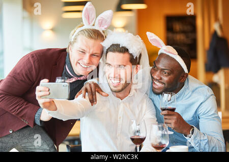 Friends at bachelor party in funny disguise take a selfie Stock Photo