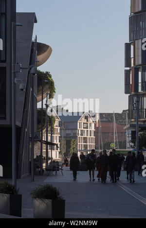 People walk in the late afternoon away from the business and restaurant area of Barangaroo South back towards the city centre and Wynyard rail station Stock Photo