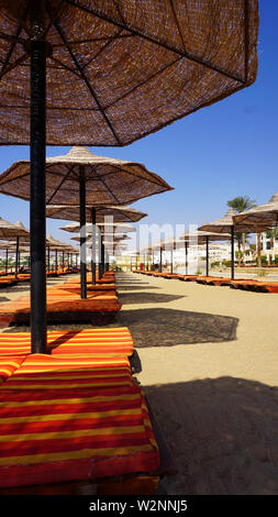 sandy beaches with umbrella and sunbeds in Egypt Stock Photo