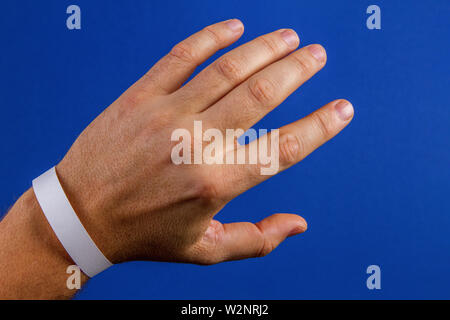 Mockup template blank paper wristband, bracelet on man arm Stock Photo