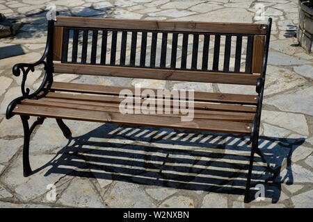 Corfu A beautiful two seated bench clean and freshly painted.A scene which all of us will have different memories some good and some not so good. Stock Photo
