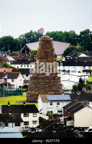 Craigyhill 11th night bonfire in Larne, Northern Ireland. Bonfires are traditionally lit in loyalist communities across Northern Ireland every year on July 11 to mark the anniversary of the Battle of the Boyne. Stock Photo