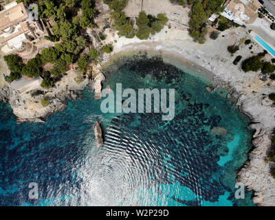 Cala en Cranc rocky seaside in the Palma de Mallorca directly from above drone point of view photo, picturesque nature stony beach turquoise sea Stock Photo