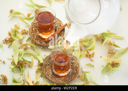Linden tea with dried linden flowers in natural environment Stock Photo