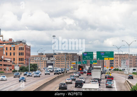 Dallas, USA - June 7, 2019: High angle view of highway in city in summer with Woodall Rodgers Freeway and traffic with cityscape and signs Stock Photo