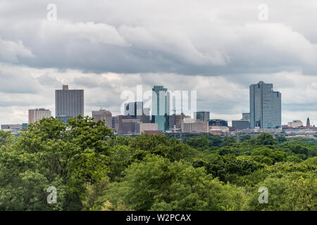 Fort Worth city in Texas with green trees in park and cityscape skyline and cloudy day Stock Photo