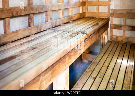 Closeup of empty wooden sauna benches with nobody in room for health Stock Photo
