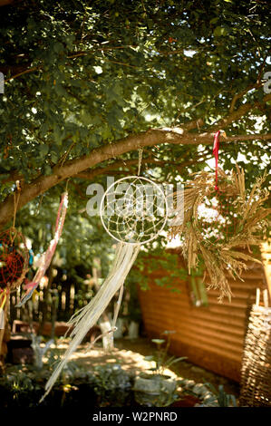 Dreamcatcher of light fabric with beads develops in the wind.Relax, children's dreams. garden of Eden. Stock Photo
