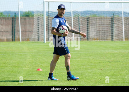 Cris the coach of Mont d'Or Azergues with the ball in his hands supervises the training on the football field Stock Photo