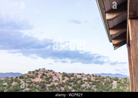 Evening in Santa Fe, New Mexico mountains in Tesuque community neighborhood house with green plants and colorful twilight and roof Stock Photo