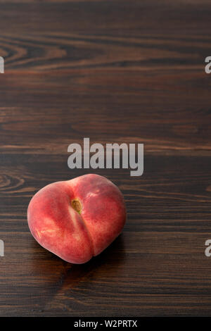 Fresh organic saturn peaches. Dark wooden table, high resolution Stock Photo
