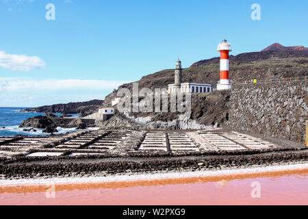 Multiple with seawater filled salt pans with two lighthouses in the background | Salinas Marinas de Fuencaliente, La Palma, Spain Stock Photo