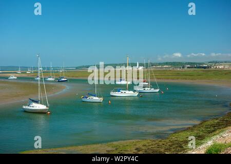 Yachts moored with Hurst Castle in the background Stock Photo