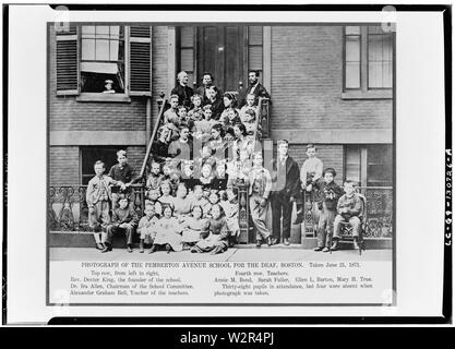 Alexander Graham Bell, teacher of teachers, seated on top step with Rev. Dexter King, founder of the school, and Dr. Ira Allen, chairman of the school committee, three steps down are teachers Annie M. Bond, Sarah Fuller, Ellen L. Barton, and Mary H. True, students are seated on the steps and standing on the sidewalk at entrance to the Pemberton Square School (Boston School for the Deaf) in Boston, Mass. Negative is of published image which includes caption identifying everyone except the students. In album: Photographs of Alexander Graham Bell : Selected by him for preservation in the Beinn Bh Stock Photo