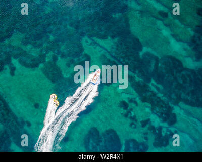 Aerial drone view of a single speedboat in the ocean.Copy Space. Stock Photo