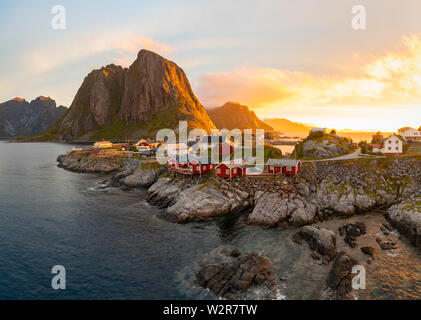 Red wooden huts, known as Rorbu, in the village of Reine on the Hamnoy island, Lofoten Islands. Rorbu is a Norwegian traditional house used by fisherm Stock Photo