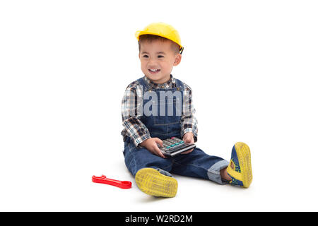 Asian Thai baby boy wearing an engineer suit with hard hat and holding calculator isolated on white background, Construction worker concept, One year Stock Photo