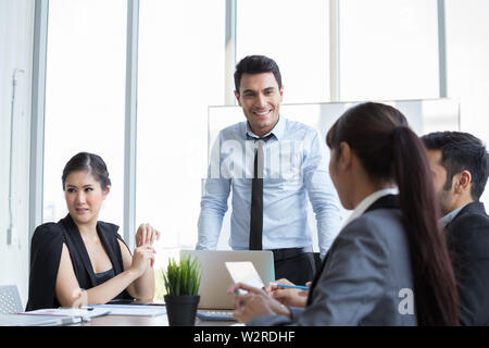 Businessman leader standing and looking for potential candidates of the team during the meeting of new project, Coach mentor excited by interesting di Stock Photo