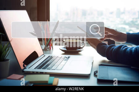 Searching and big data concepts with male hand using smart phone with search engine icon sign.Business information.global network system Stock Photo